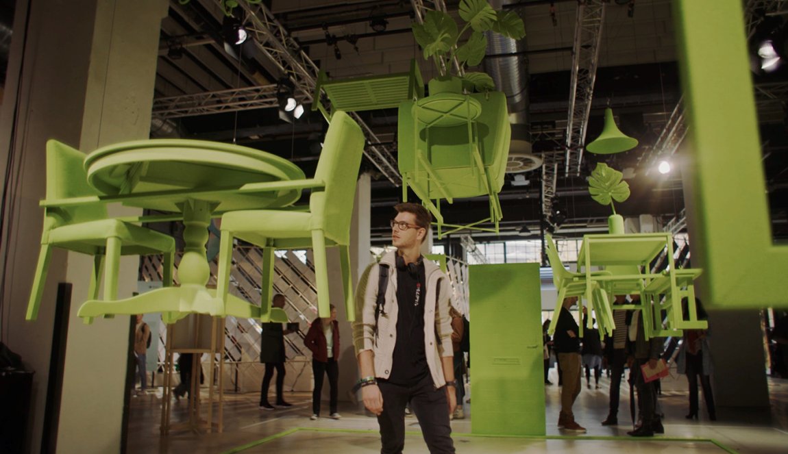 Visitor among green flying furniture during Dutch Design Week Visitor among green flying furniture during Dutch Design Week