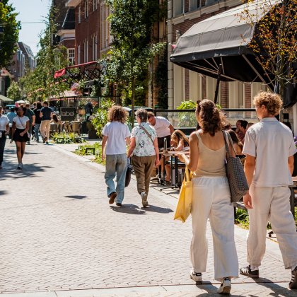 People enjoying outdoor terraces and local shops in Bergen, North Holland