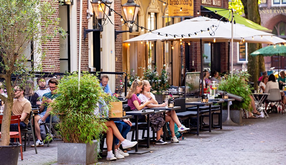 People on terraces at Mariaplaats in Utrecht