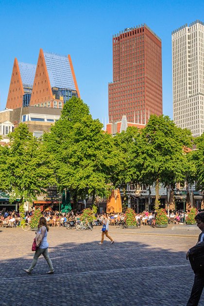 Strollers on the Plein with The Hague skyline in the background