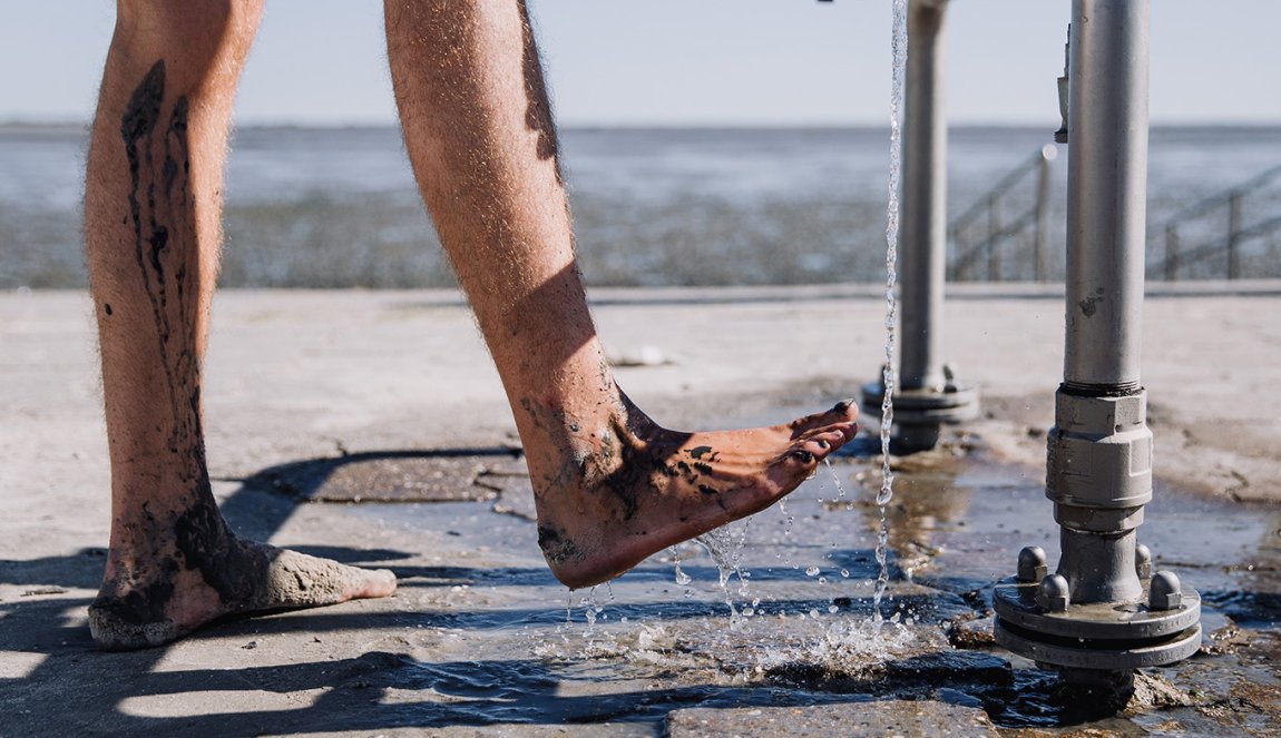 Rinsing feet clean after mudflat hiking