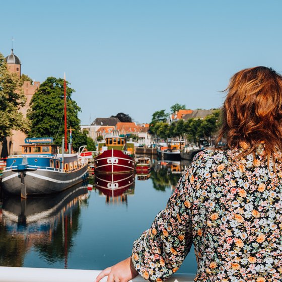 Judith Elders looks down on the water with boats from the bridge