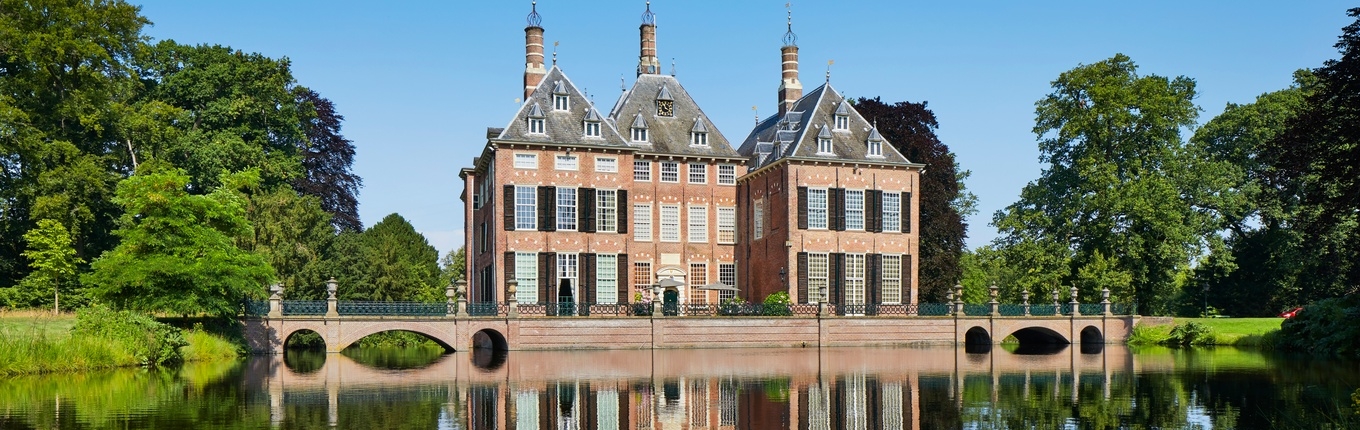 Exterior of Duivenvoorde Castle with pond Exterior of Duivenvoorde Castle with pond