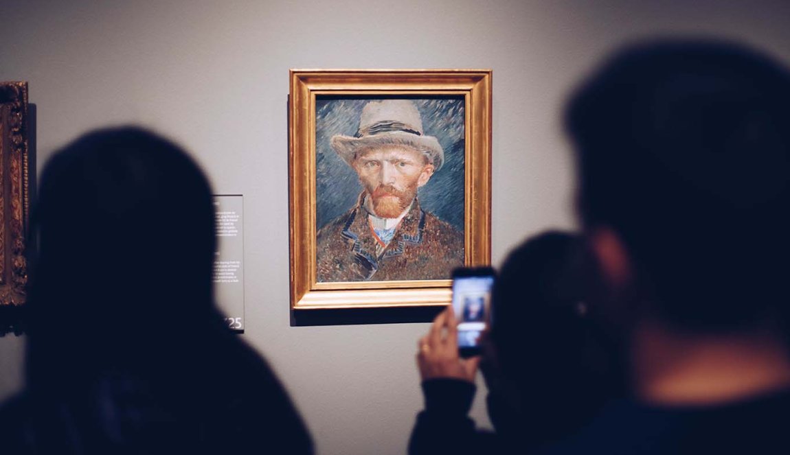 People passing by Vincent van Gogh’s self portrait and snapping a photo Rijksmuseum Amsterdam