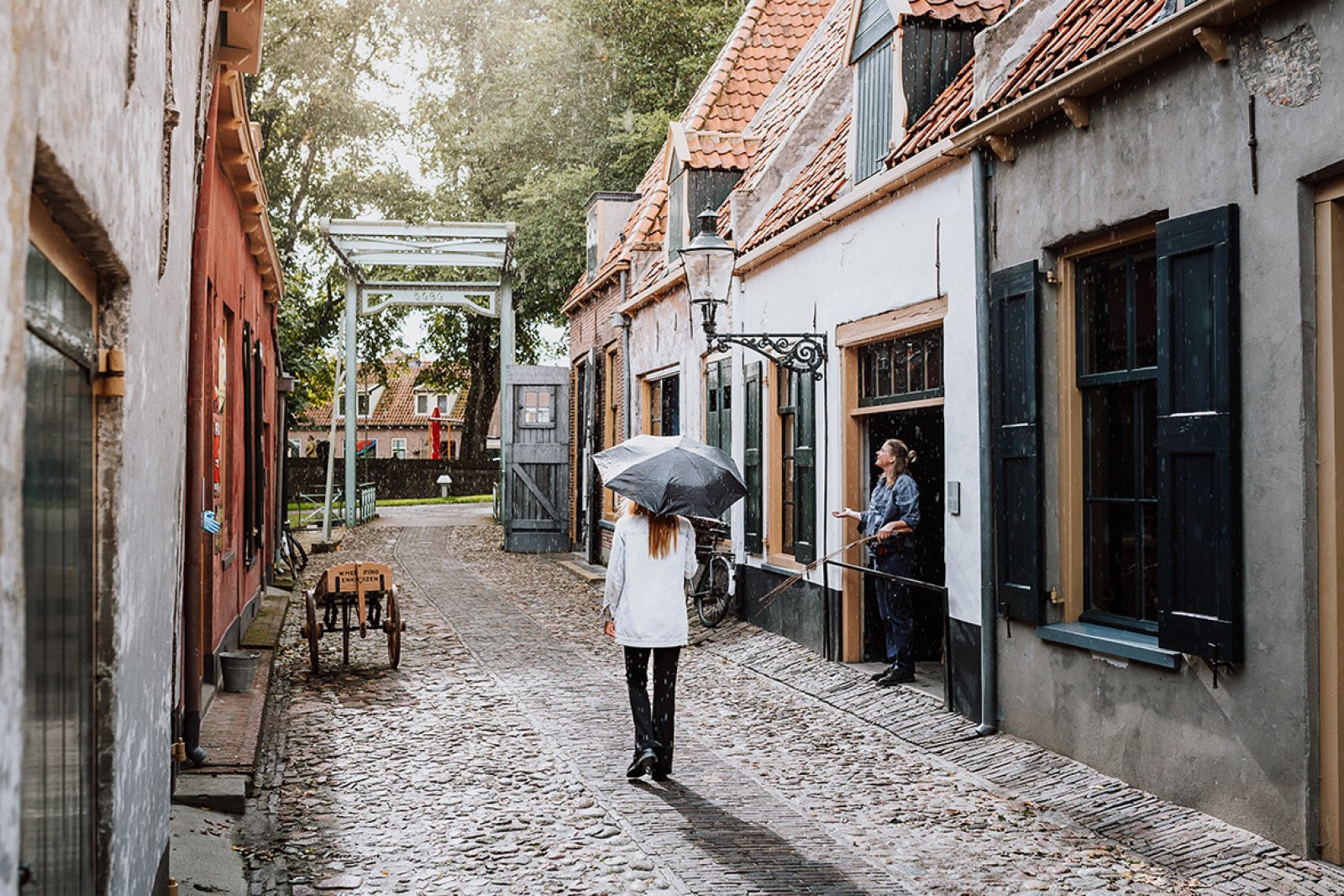 Lady walks through characteristic street Enkhuizen