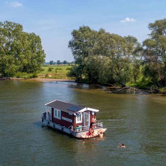 Camping on the water in a floating log cabin boat