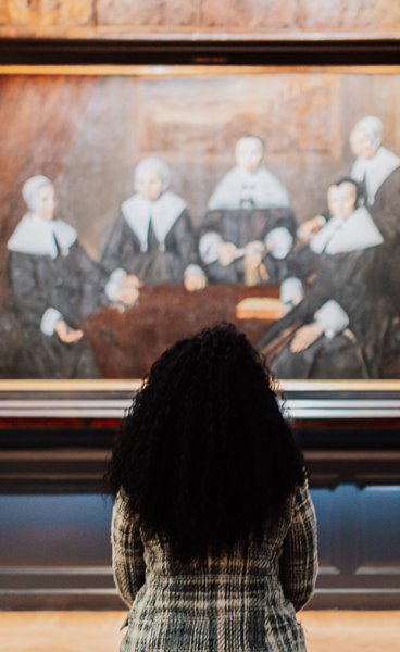 Lady views painting in Frans Hals Museum Haarlem
