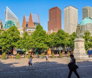 Strollers on the Plein with The Hague skyline in the background