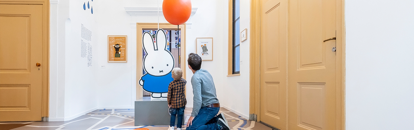 Father and child looking at Miffy in Miffy museum Utrecht Father and child looking at Miffy in Miffy museum Utrecht