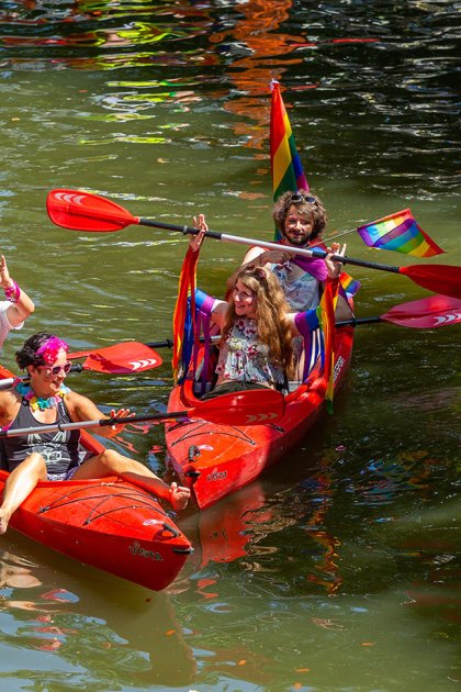 Pride Amsterdam boat filled with revellers during the Canal Parade on Amsterdam&rsquo;s canals
