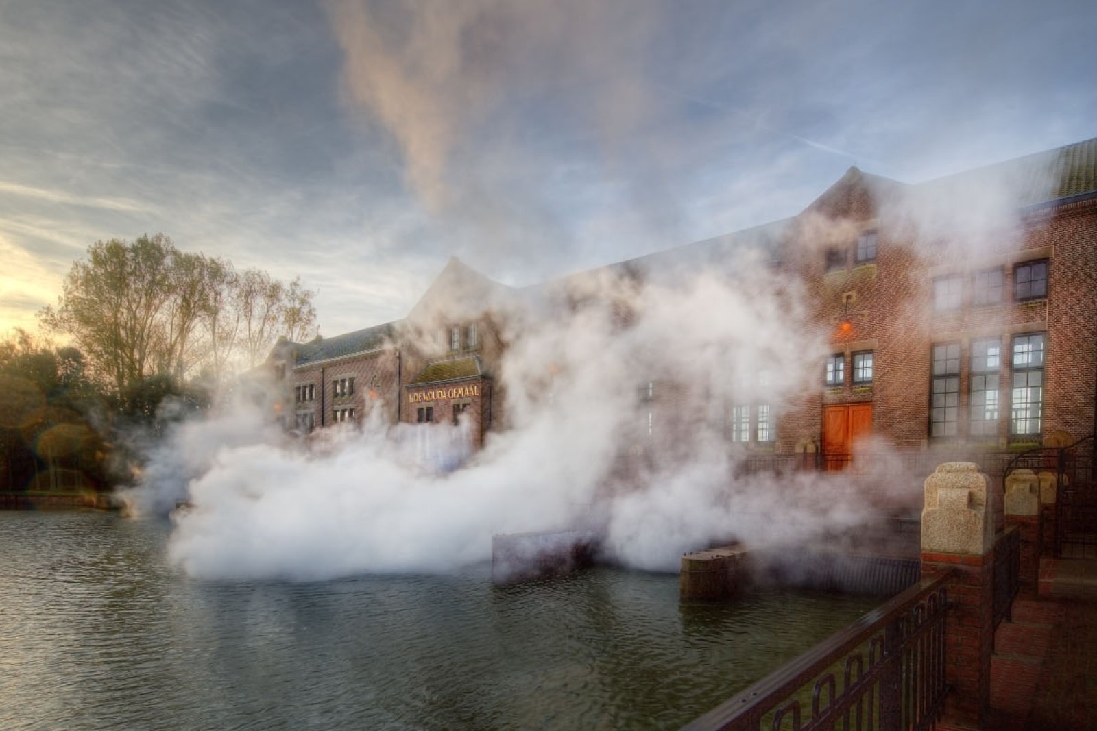 Woudagemaal pumping station with steam coming out of the building