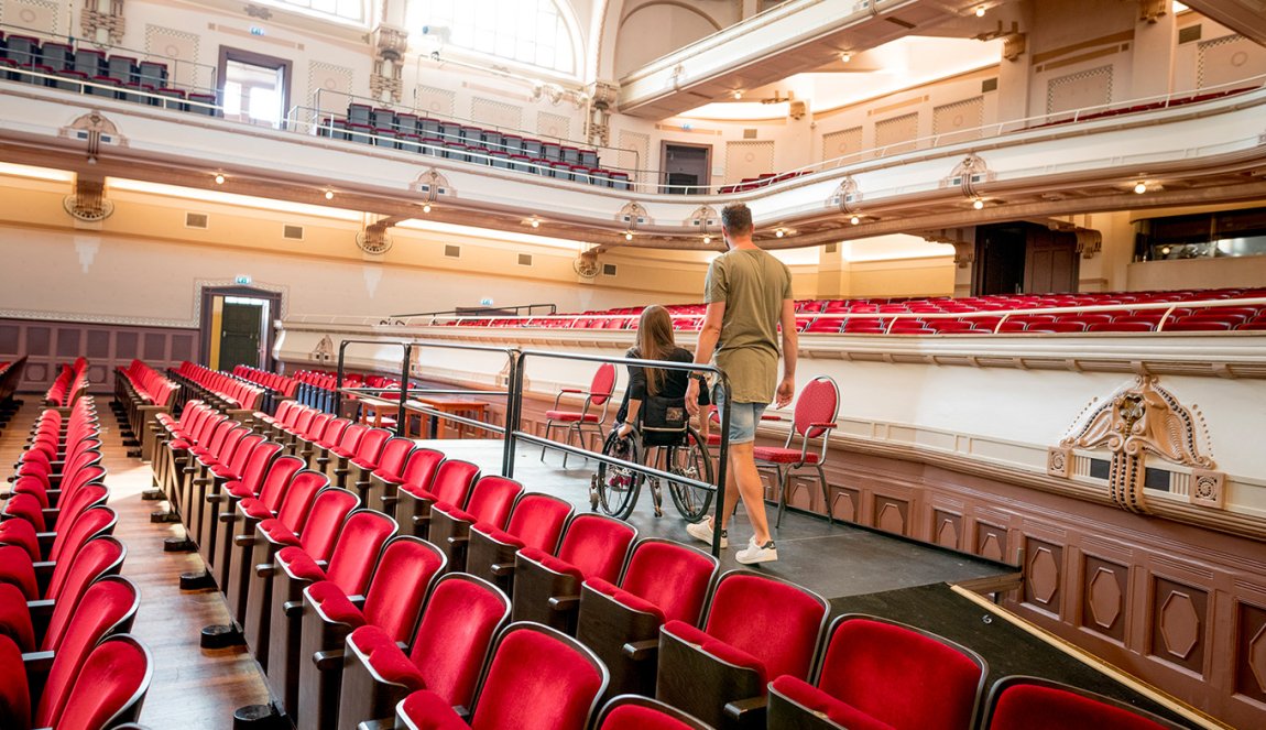 Couple visits Concertgebouw de Vereeniging Nijmegen. Lady is in a wheelchair. Couple visits Concertgebouw de Vereeniging Nijmegen. Lady is in a wheelchair.