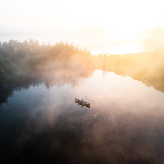 Sailing through morning mist, a boat on the Berkel near Haarlo