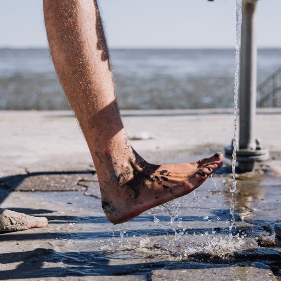 Rinsing feet clean after mudflat hiking