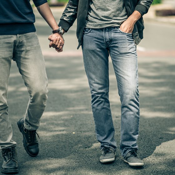 Men walking hand in hand on the street