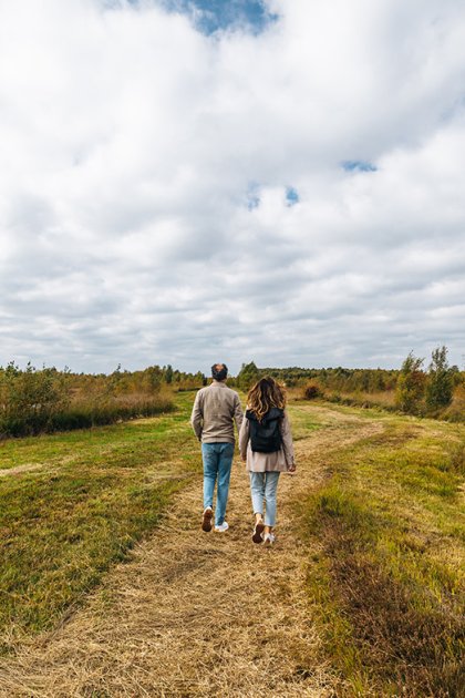 Couple walks on untrodden paths Nature reserve Bargerveen Drenthe