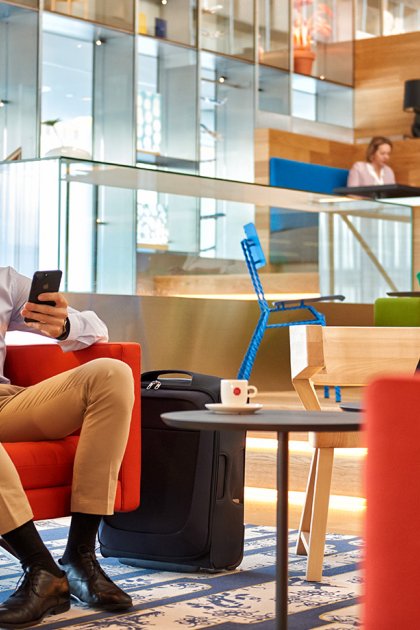 Business travellers relaxing and working in the KLM Crown Lounge at Amsterdam Airport Schiphol