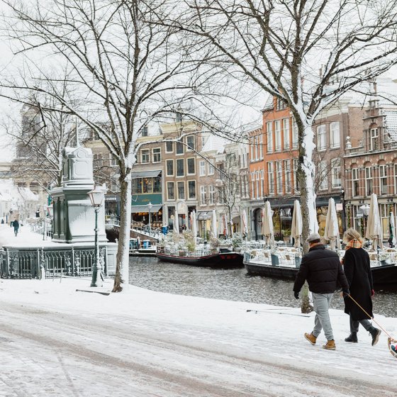  Family on a sledge along snowy paths beside the canal