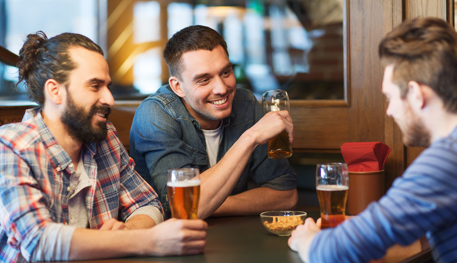 Male friends drinking beer at the pub