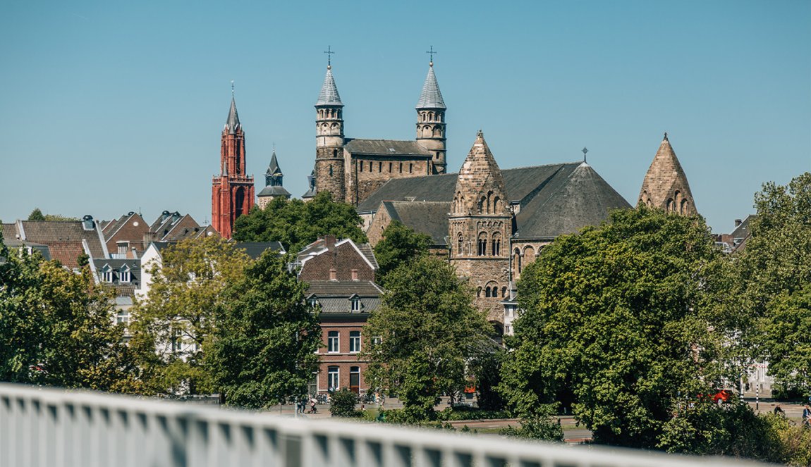 Maastricht view from the bridge to the city with monumental buildings.