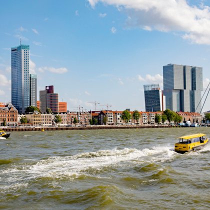 Water taxi against the Rotterdam skyline