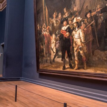 Visitors viewing Rembrandt&rsquo;s The Night Watch at the Rijksmuseum in Amsterdam, one of the Netherlands&rsquo; most famous Dutch Master paintings