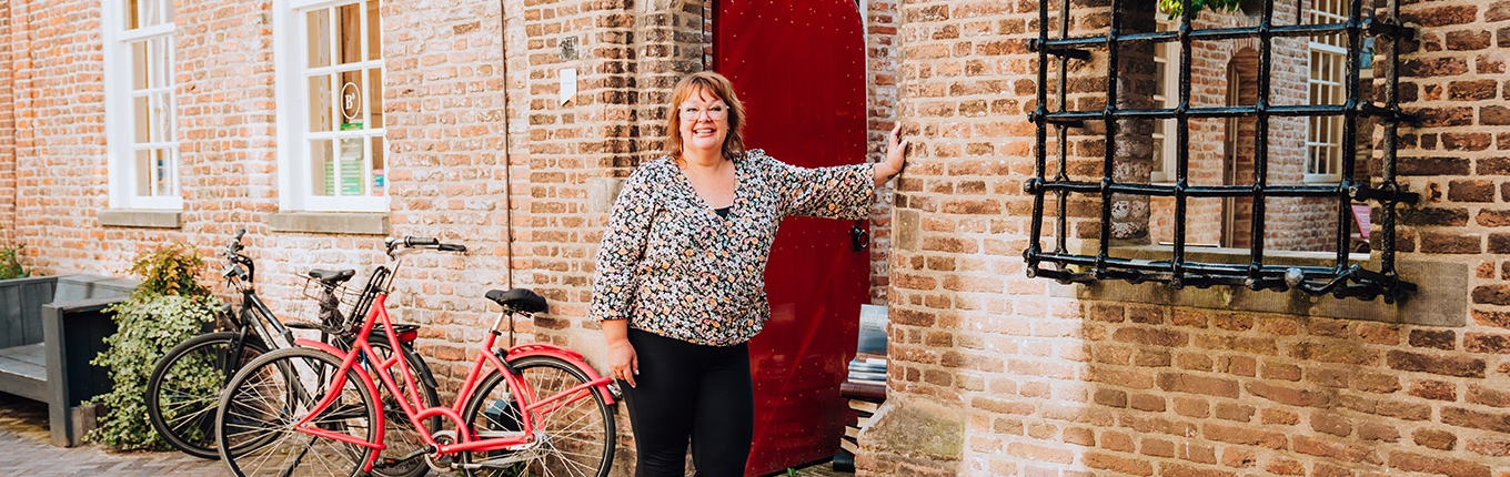 Judith Elders against building with red door Judith Elders against building with red door