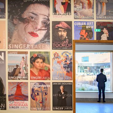 Wall with posters from the Singer Laren Museum