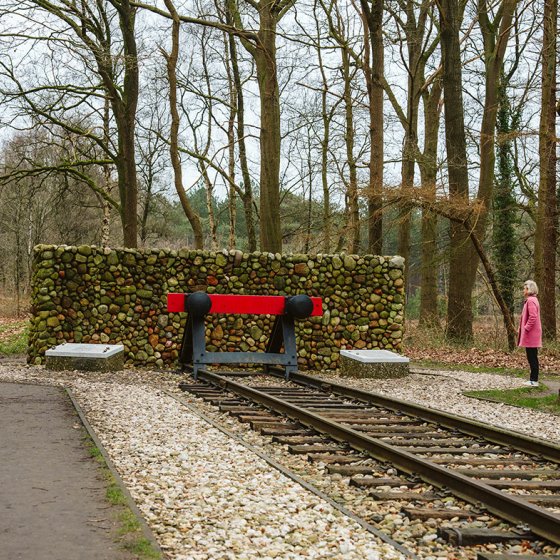 Camp Westerbork Assen lady looks at tram rails, terminus