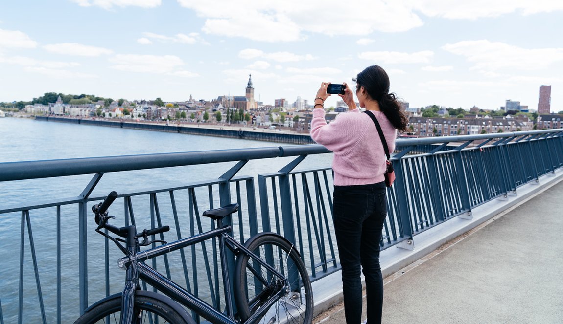Bicyclist takes photo from bridge