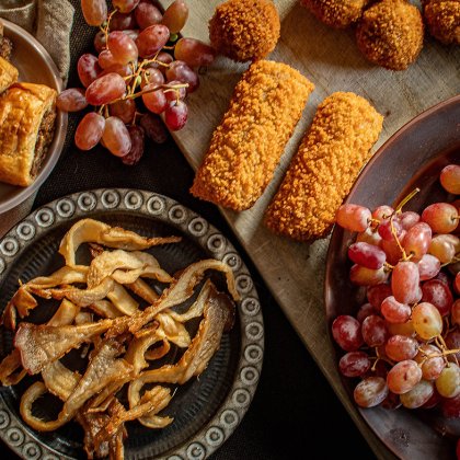 Wooden board with vegetable bitter clusters from oyster mushrooms