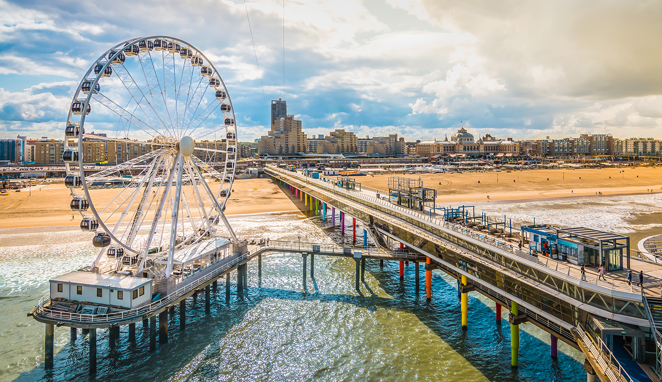 Ferris wheel and pier at the beach Scheveningen Ferris wheel and pier at the beach Scheveningen