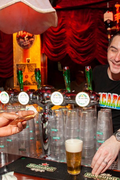 Bartender serves beer in gay bar Rotterdam
