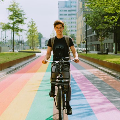 Man cycles along rainbow bike path in Utrecht